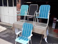 All four chairs displayed on table outside garage