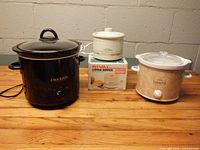 Three slow cookers displayed together