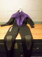 Full wetsuit laid flat showing overall condition, front zip, color scheme