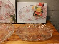 Both Studio Nova Beauty Rose serving pieces beside their original boxes