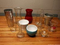 All thirteen vases and planters grouped together on wood surface