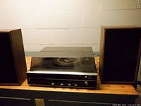 Stereo unit flanked by two speakers, overall view