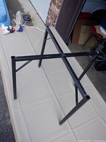 Overall view of black metal stand on table