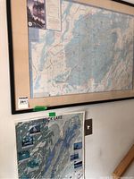 Framed Frontenac map and Buck Lake map displayed on wall