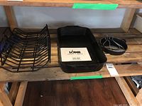Rectangular Lodge fish pan with paper insert and black wire rack beside it