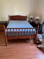 Full view of queen bed frame with mattress and box spring