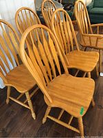 Six wood dining chairs grouped together