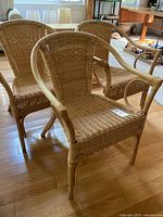 Front view of three wicker armchairs together