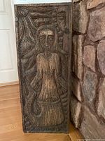 front view of carved plaque showing mermaid figure