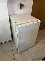 Front and side view of the white Danby bar fridge