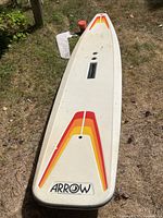 Full view of Arrow paddle board with rudder and safety line