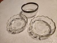 Overview of all three glass condiment bowls on table surface