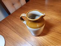 Full view of jug showing two-tone glaze and handle