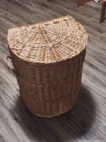 Front view of half-round wicker hamper with closed lid