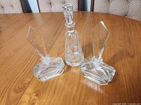 Front view of three perfume bottles with stoppers inserted