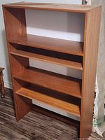 Front angled view of bookcase showing open back and adjustable shelves