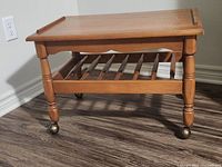 Angled view showing full table on casters with magazine rack