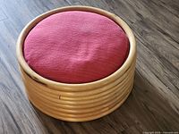 Ottoman angled view showing bamboo frame and cushion