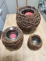 All three vine-wrapped glass candle holders on tabletop, showing size differences and candle placement