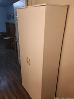 Cabinet closed showing white exterior, bar pulls