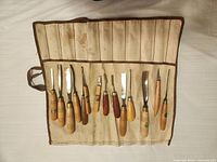 Canvas roll open showing 14 carving tools