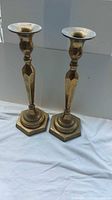 Front view showing pair of brass candlesticks