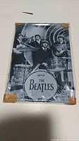 Full view of Beatles tin sign inside plastic sleeve