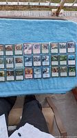 Binder sheet showing 28 sleeved Magic: The Gathering cards