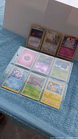 Front view of binder sheet showing all nine Pokémon cards