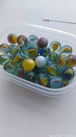 Top view of container showing quantity and variety of marbles