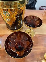 Ice bucket and coupe glasses showing matching gold and enamel decoration