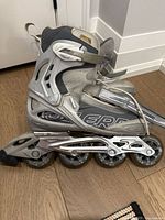 Side view of both skates showing brand graphics and wheel setup