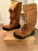 Side view of both boots on UGG box