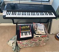 Front view of Casio PRO-200 keyboard on stand with stool and sheet music