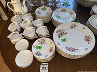 Group view of Royal Worcester Roanoke dinnerware on table showing plates, cups, bowls, teapot, creamer