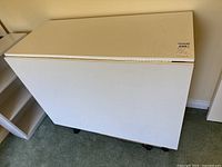 Desk folded, showing white laminate top and sides