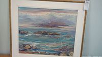 Full view of framed seascape painting with lighthouse, mat and frame visible