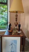 overall lot view with side table, lamp, figurines, artwork