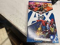 Front view of sealed Avengers vs X-Men Companion hardcover in slipcase