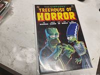 Front view of the bagged and boarded comic showing title, issue number, cover art, and writers