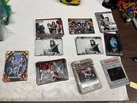 Overview of assorted KISS trading card stacks laid out on table