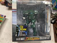 Front of sealed collector’s set showing figurine and Best Buy exclusive label