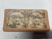 Front of stereoview card showing twin sepia images and printed caption