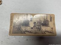 Front of stereoview showing twin sepia images, publisher imprint and caption