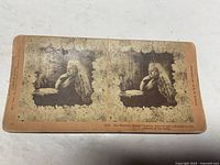 Front of stereoview card showing dual images of Queen Victoria with floral border and caption