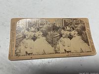 Front of stereocard showing twin sepia images, publisher credits on margins, title printed below images