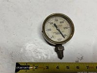 Front of gauge showing dial, scale and needle