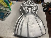 Top view of Wilton aluminum Barbie Flowing Hair cake pan showing overall shape and details