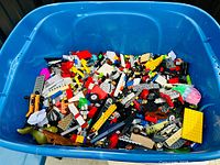 Top view of blue tote filled with mixed LEGO pieces