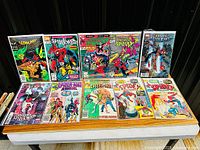 Twelve bagged Spider-Man comics laid out on table